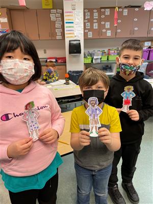 Photo shows Harding students with cutout colored papers of Katherine Johnson.